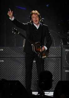 Sir Paul McCartney strikes a trademark pose while on stage in NYC (Photo: Live4ever)