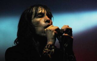 A photo of bobby gillespie performing with primal scream
